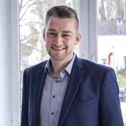 lächelnder Mann im dunkelblauen Anzug